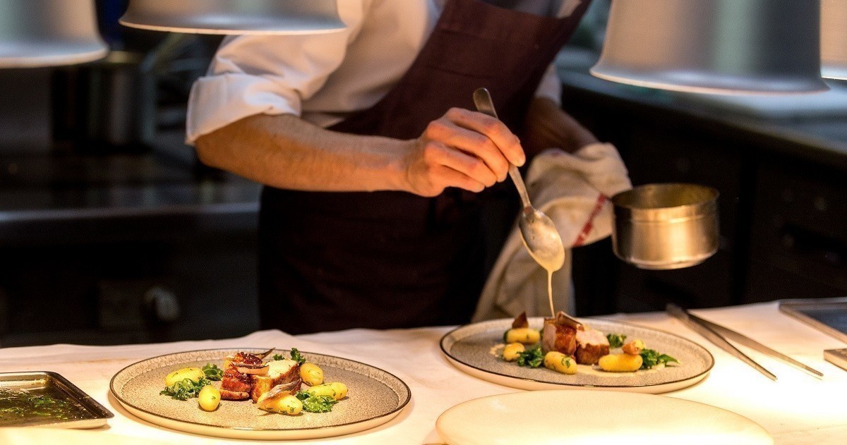 Chef plating in professional kitchen